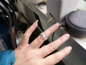 Hnad showing off the Celtic spirals wedding ring