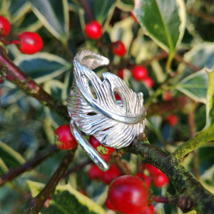 Sterling silver angel feather ring, filled with love and protects the wearer. Part of Elena Brennan's My Angel jewelry collection. Celtic inspired angel jewelry designed and handcrafted in Co. Cavan, Ireland. Photographed against a red berry bush.
