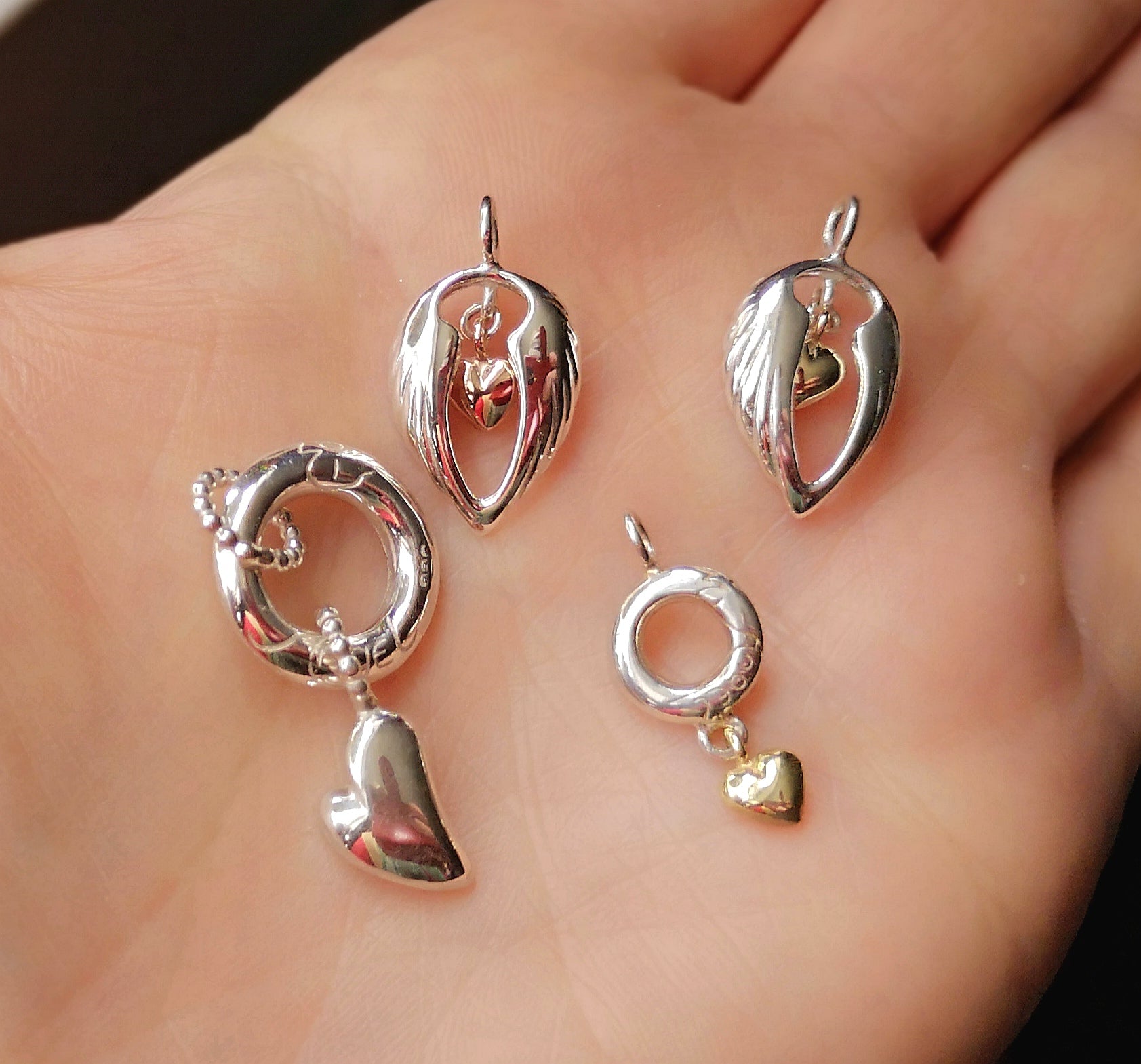 The Angel halo and heart pendant alongside similar sterling silver angel pendants.
