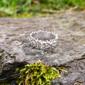 Shiny sterling silver Bubble Ring with a buckle effect pattern and little bubble decorations. Designed and handmade in Ireland.