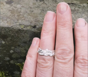 A hand showing off the Celtic Spirals Wedding Rung, created by Elena Brennan. This Irish wedding ring was handmade in Ireland.