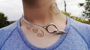 A woman wearing the Sterling Silver Torc Necklace, made in Ireland. This torc jewelry piece is inspired by the Irish legend, The Children of Lir