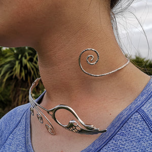 A woman wearing the Sterling Silver Torc Necklace, made in Ireland. This torc jewelry piece is inspired by the Irish legend, The Children of Lir