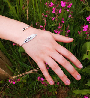 The Earth Angel Feather Bracelet looks gorgeous when worn, handcrafted in sterling silver by Irish Jewellery Designer Elena Brennan, photographed in nature setting
