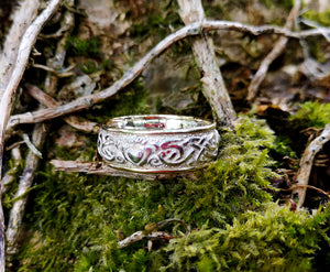 Celtic Claddagh wedding ring with intricate detailing handmade by Elena Brennan Jewellery with 9ct yellow 1.3mm bands either side. This Celtic jewelry piece is perched on tree moss