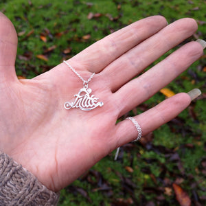 An idea of the size of the unique Irish sterling silver pendant Fáilte. This Gaelic welcome pendant is perched on the palm of a hand