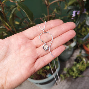 The Lily Peace Pendant is handmade from sterling silver by Elena Brennan Jewellery and complete with a gold stem.