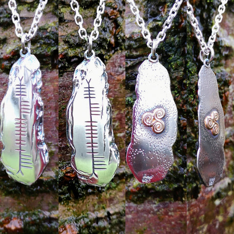 Silver pendants inscribed with Ogham writing, an early form of the Irish language writing system. These ogham pendants are handcrafted in Ireland by Elena Brennan