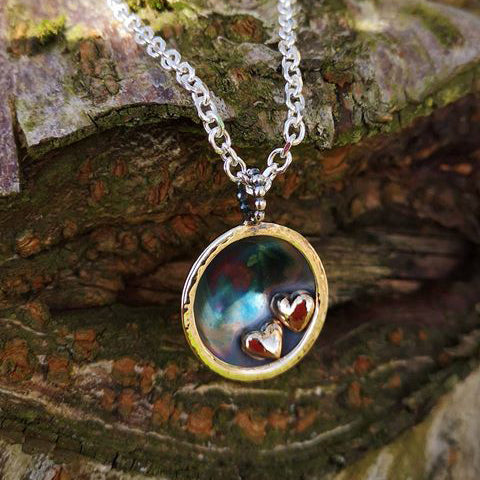 A bespoke pendant handmade as a meaningful gift for an expecting mum complete with two 14ct gold hearts.