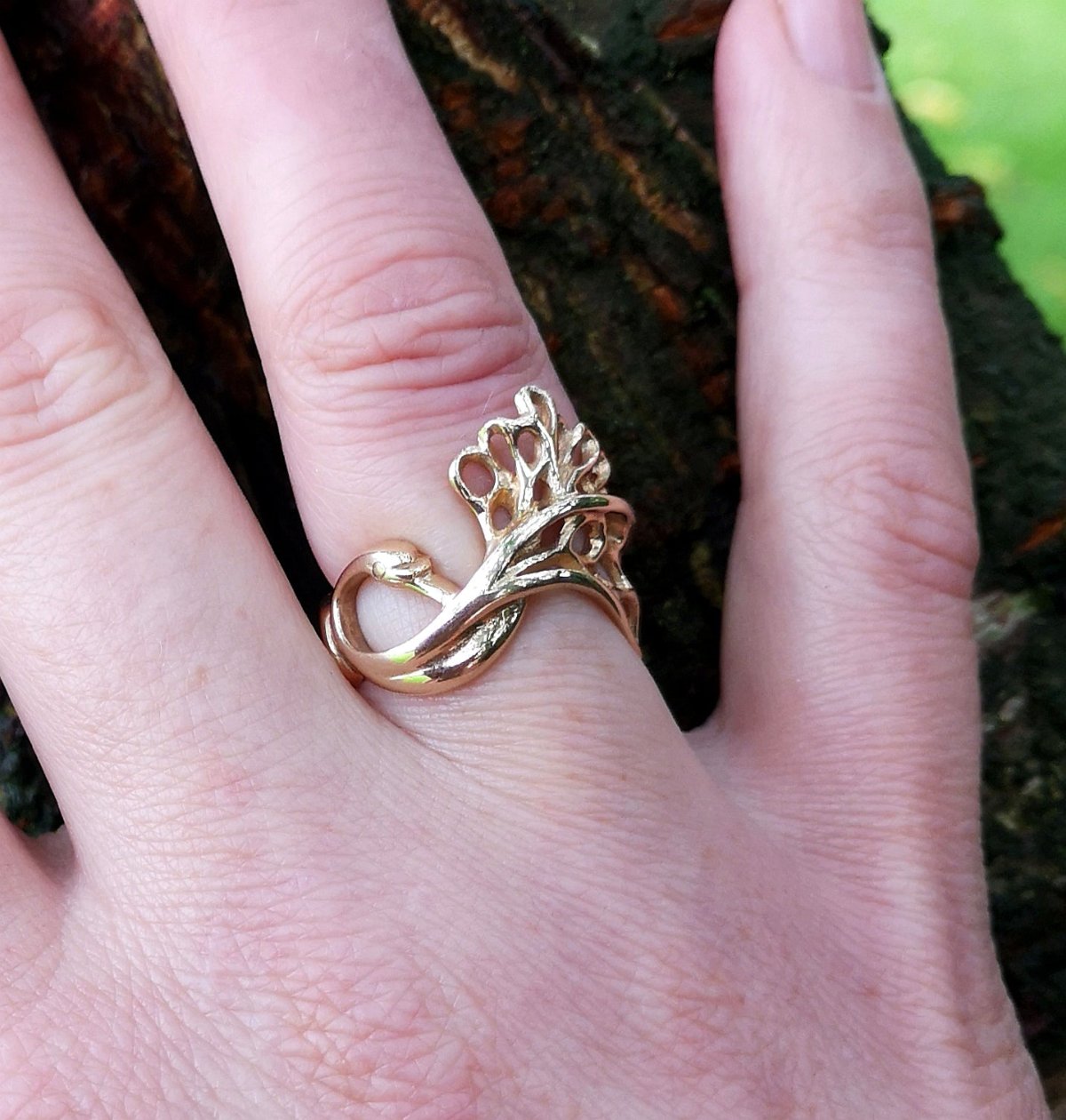 Gold swan ring for a wedding anniversary gift.