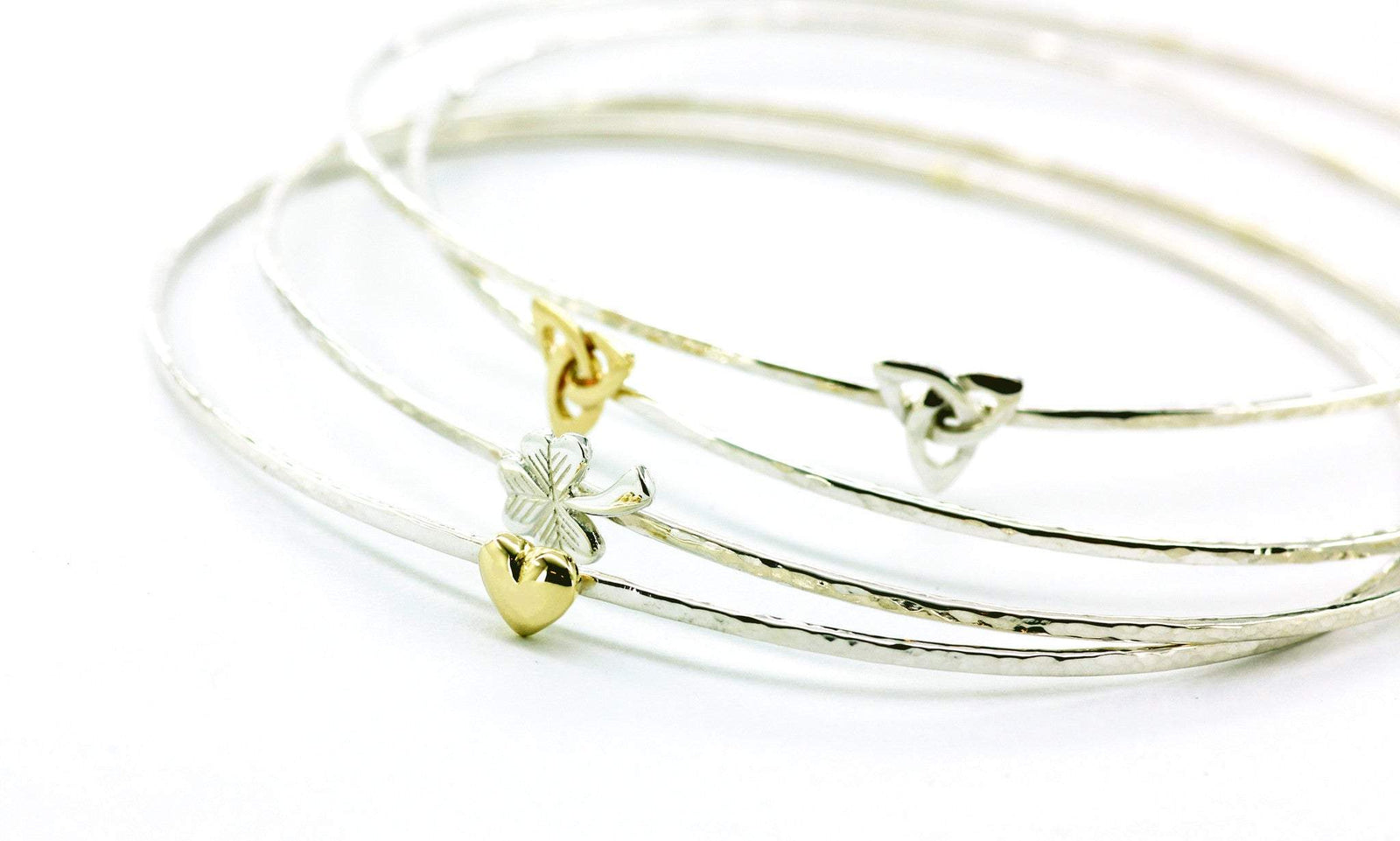 Sterling silver beaten stacking bangles with Celtic symbolism, handmade in Cavan, Ireland.