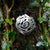 Cavan (An Cabhán) Brooch made of sterling silver, sitting on tree bark. This irish design jewellery piece is inspired by the landscape of County Cavan.