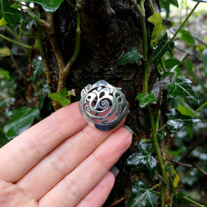 Cavan (An Cabhán) Brooch made of sterling silver, sitting on tree bark. This Irish design jewellery piece is inspired by the landscape of County Cavan.