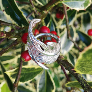 Sterling silver angel feather ring, filled with love and protects the wearer. Part of Elena Brennan's My Angel jewelry collection. Celtic inspired angel jewelry designed and handcrafted in Co. Cavan, Ireland. Photographed against a red berry bush.