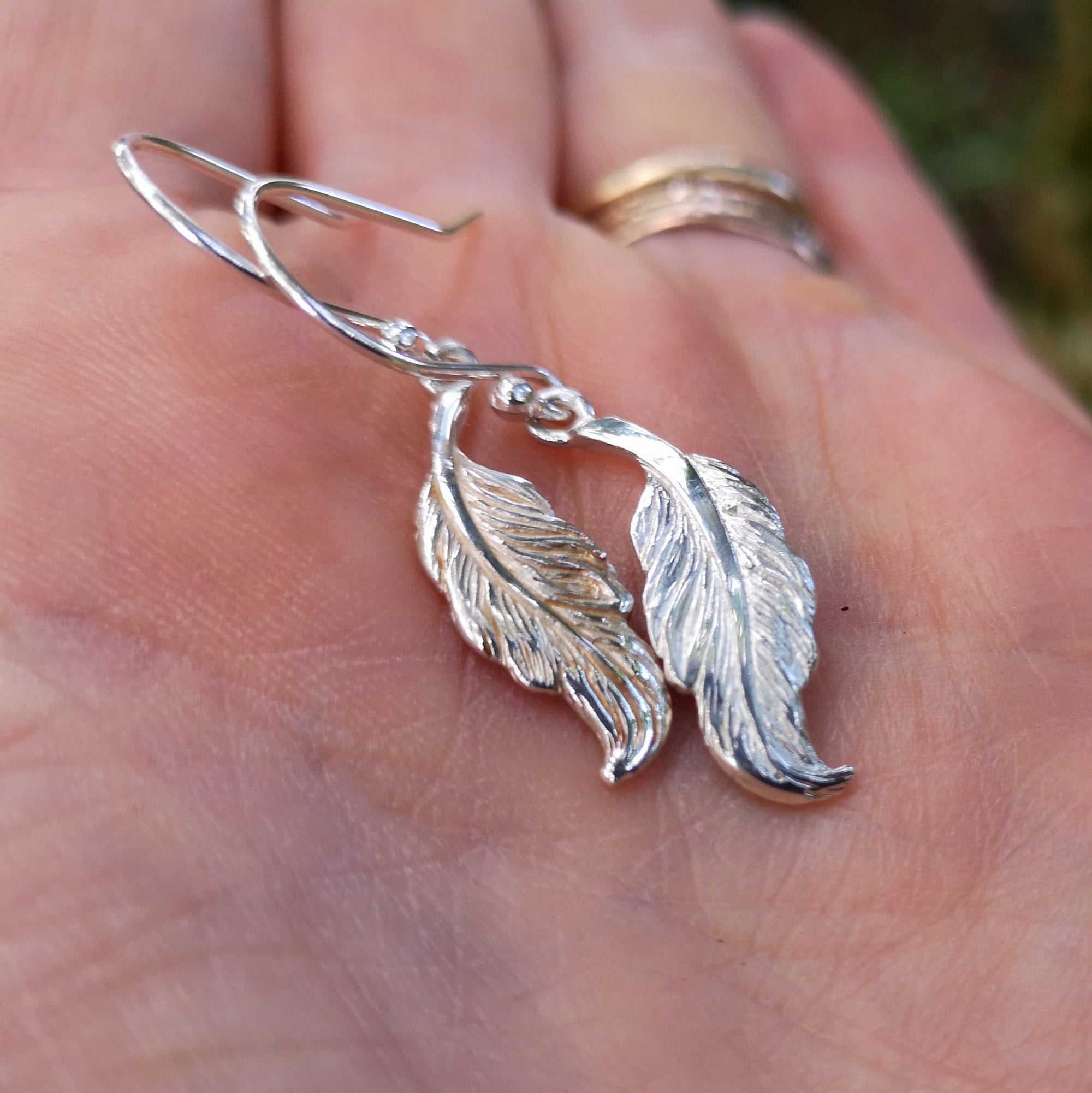 Small sterling silver angel feather drop earrings.