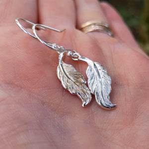 Small sterling silver angel feather drop earrings.