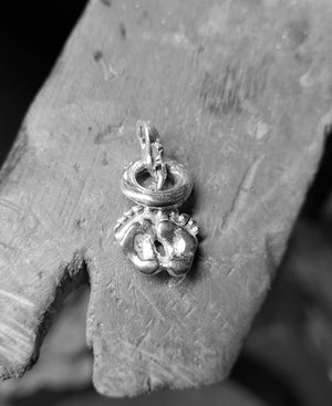 Tiny Baby Footprint Charm handmade from sterling silver is complete with a tiny angel halo charm.