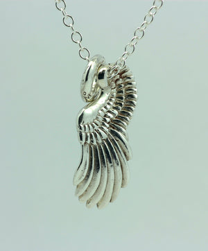 The curvey sterling silver Angel Wing pendant with an angel halo. This angel necklace is part of the My Angel jewellery collection, handmade in Ireland.
