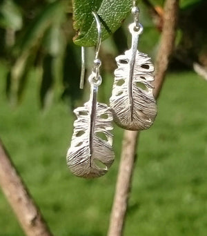 These Irish sterling silver Baby Angel Feather Drop Earrings are a reminder to a loved one of the angels presence always. The earrings are hanging from a branch and are part of the My Angel jewellery collection.