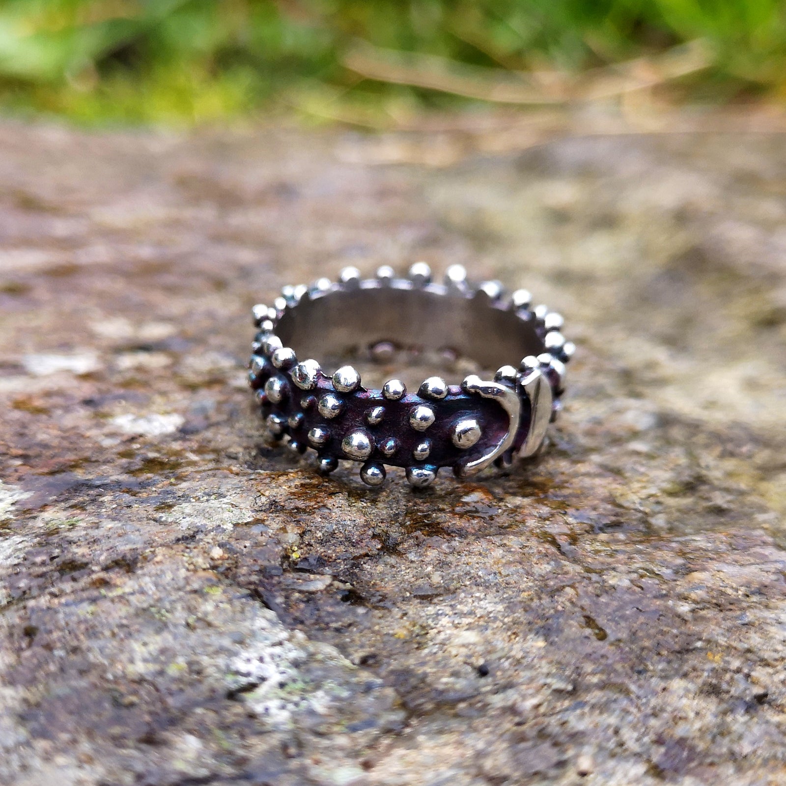 Blackened sterling silver Bubble Ring with a buckle effect pattern and little bubble decorations. Handmade in Cavan, Ireland by Irish jewellery designer Elena Brennan