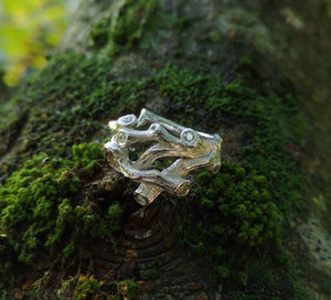 A sterling silver family birthstones ring in the shape of twigs that can also function as an Irish wedding ring or promise ring. Handmade in Cavan, Ireland.