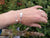 A woman wearing the "Cherish" Baby Angel Feather Bracelet from Elena Brennan's My Angel jewellery collection. This bracelet is made from Irish Sterling Silver.