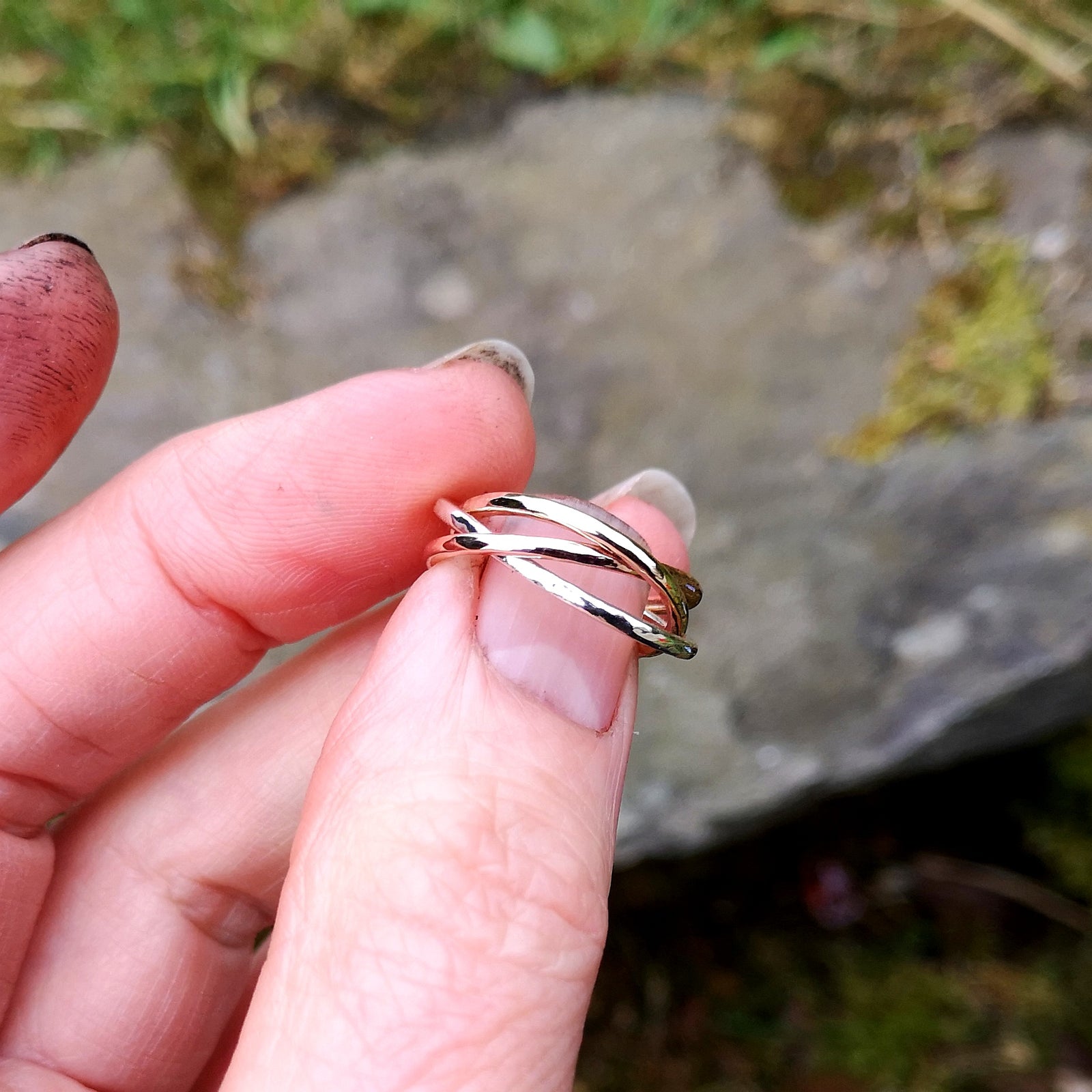 A bespoke circle of life ring made of gold, silver and sterling silver.