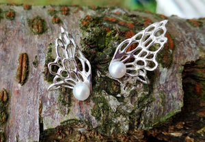 Gorgeous Gossamer Wave Communion Earrings with a precious pearl at the centre sitting on mossy tree bark. Handmade by Elena Brennan in Ireland, these are the perfect First Holy Communion Earrings for a special girl.