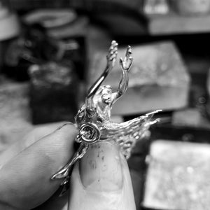 Close up of the delicate sterling silver guardian angel pendant.