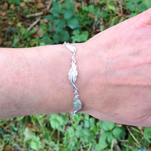 Little angel feather bracelet with five angel feathers.