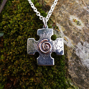 Crux Quadrata pendant with gold Celtic spiral at the centre. Handmade in Ireland.