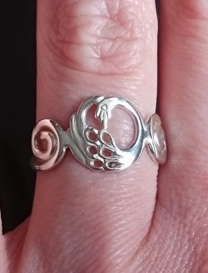 Finger wearing the Disc Swan Ring, part of the Children of Lir Jewelry Collection.