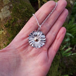 This Dog Daisy pendant is made of sterling silver and gold. Daisy Jewellery handmade in Ireland by Elena Brennan.