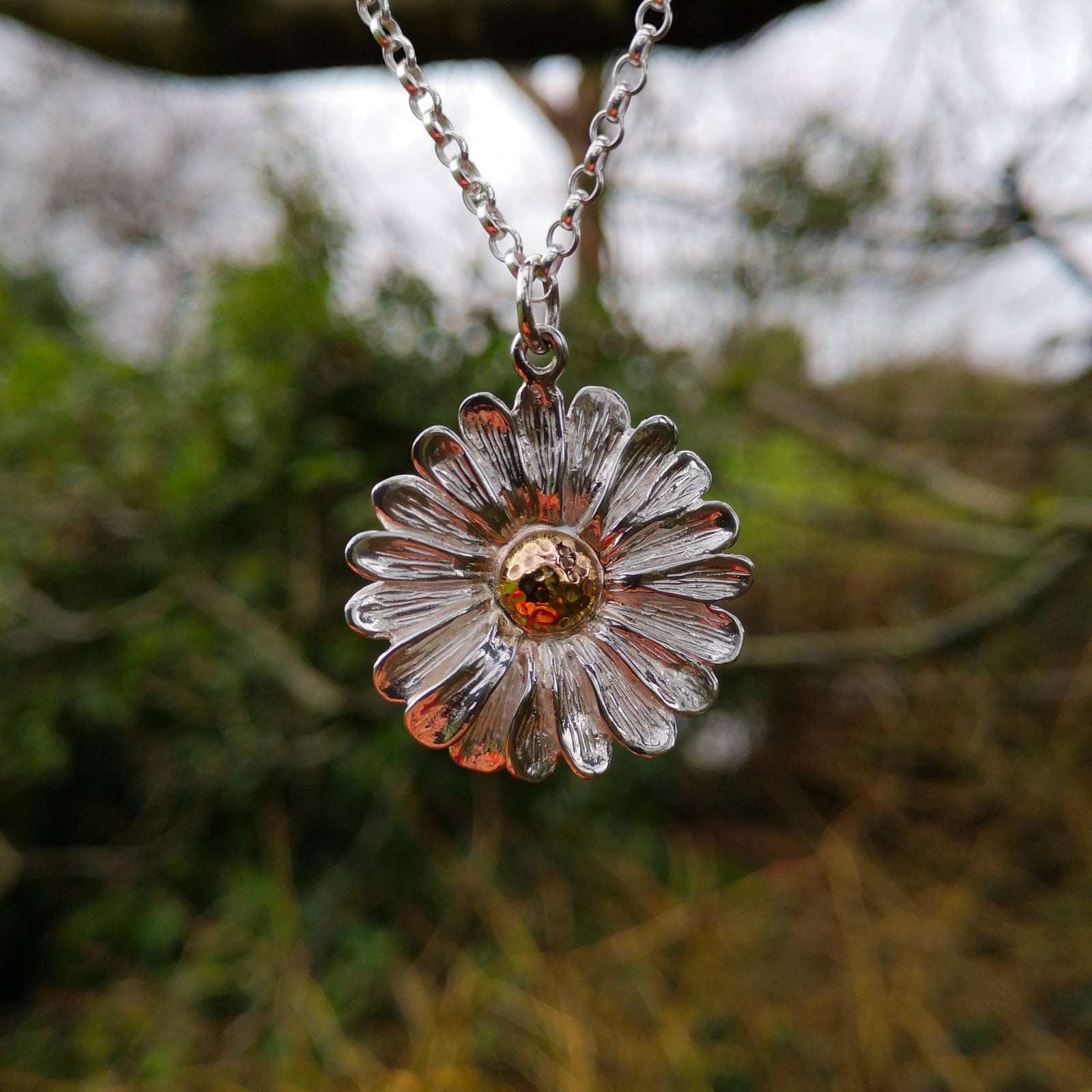 This Dog Daisy necklace is made of sterling silver and gold. Daisy Jewellery handmade in Ireland by Elena Brennan.