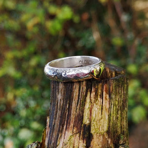 The Love Forever Ring is sitting on tree bark and is handmade by Irish Jewellery Designer Elena Brennan, complete with a 14ct gold heart.