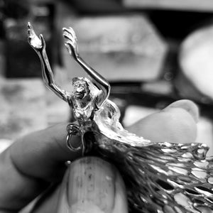 A guardian angel with outstretched arms pendant.