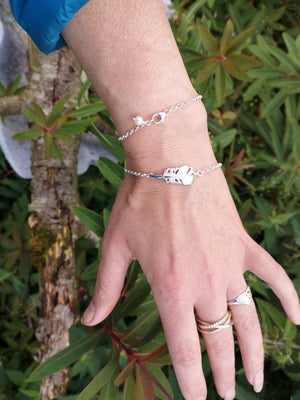 A woman showing off the "Cherish" Baby Angel Feather Bracelet from Elena Brennan's My Angel jewellery collection, is made from Irish Sterling Silver.