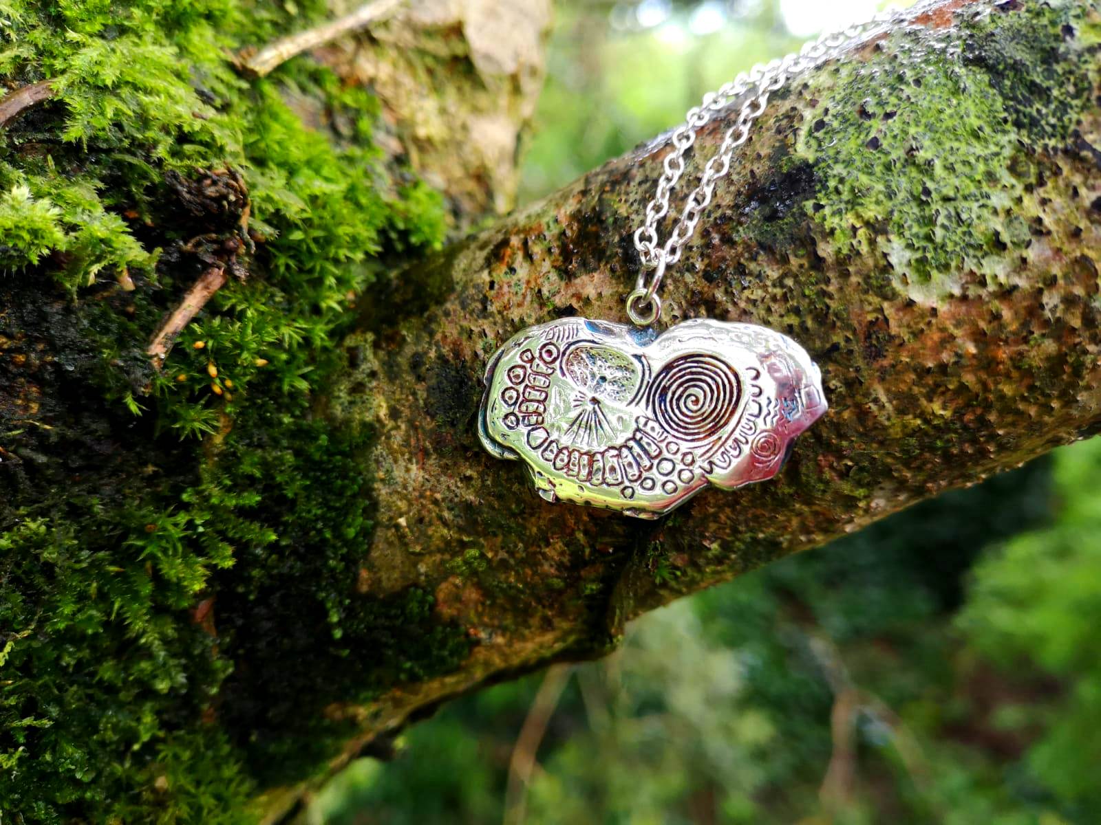 Detailed handmade Knowth kerbstone pendant made of sterling silver, inspired by the Neolithic burial chamber in Meath, by Elena Brennan Jewellery