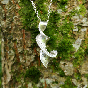 The Mara pendant, made of twisted sterling silver with a spiralling motion. Bespoke jewellery made in Ireland.