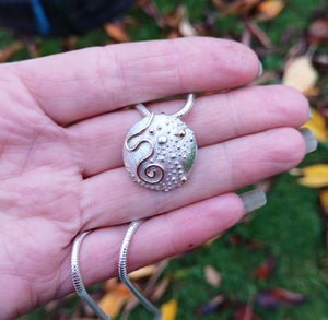 Detail of Silver Cúrsa an tSaoil pendant, handmade in Cavan, Ireland.