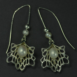 Lacy sterling silver earrings with a pearl nestled in it's centre. Handmade and designed in Ireland by Elena Brennan Jewellery.