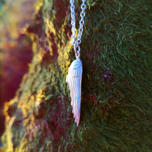 Right-folded angel wing pendant made of sterling silver.