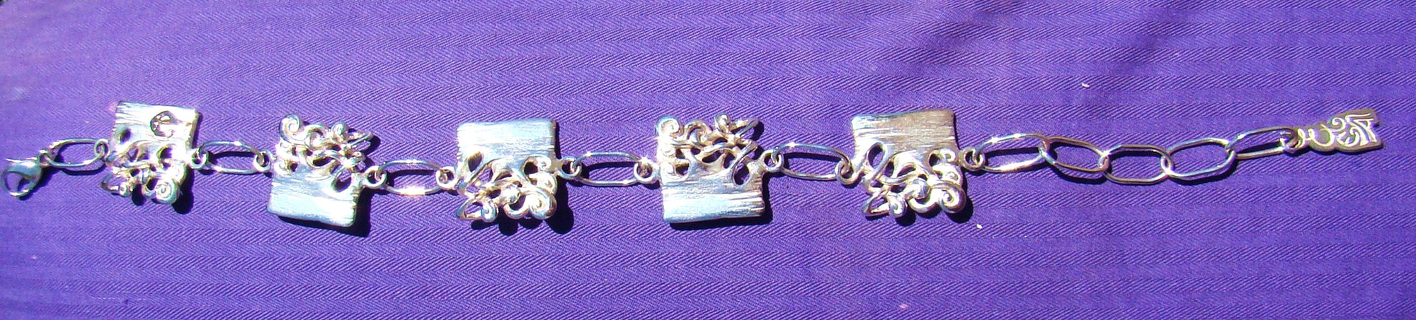 Bog Book Bracelet With Gold Letter detailing, handcrafted from Sterling Silver.