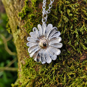 This Dog Daisy pendant is made of sterling silver and gold. Daisy Jewellery handmade in Ireland by Elena Brennan.