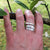 A hand wearing the Earth Angel Feather Ring, a sterling silver angel ring made in Cavan, Ireland.