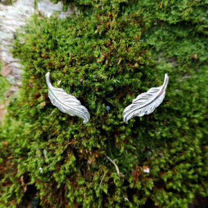 Small angel feather stud earrings made of sterling silver.