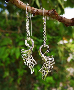 Swan Drop Earrings made from Sterling Silver, hanging from a tree branch. Inspired by the Irish legend, the Children of Lir, and handmade in Ireland.
