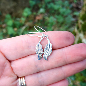 Small sterling silver angel feather drop earrings.