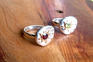 Sea themed sterling silver and gold rings set with garnet and peridot.