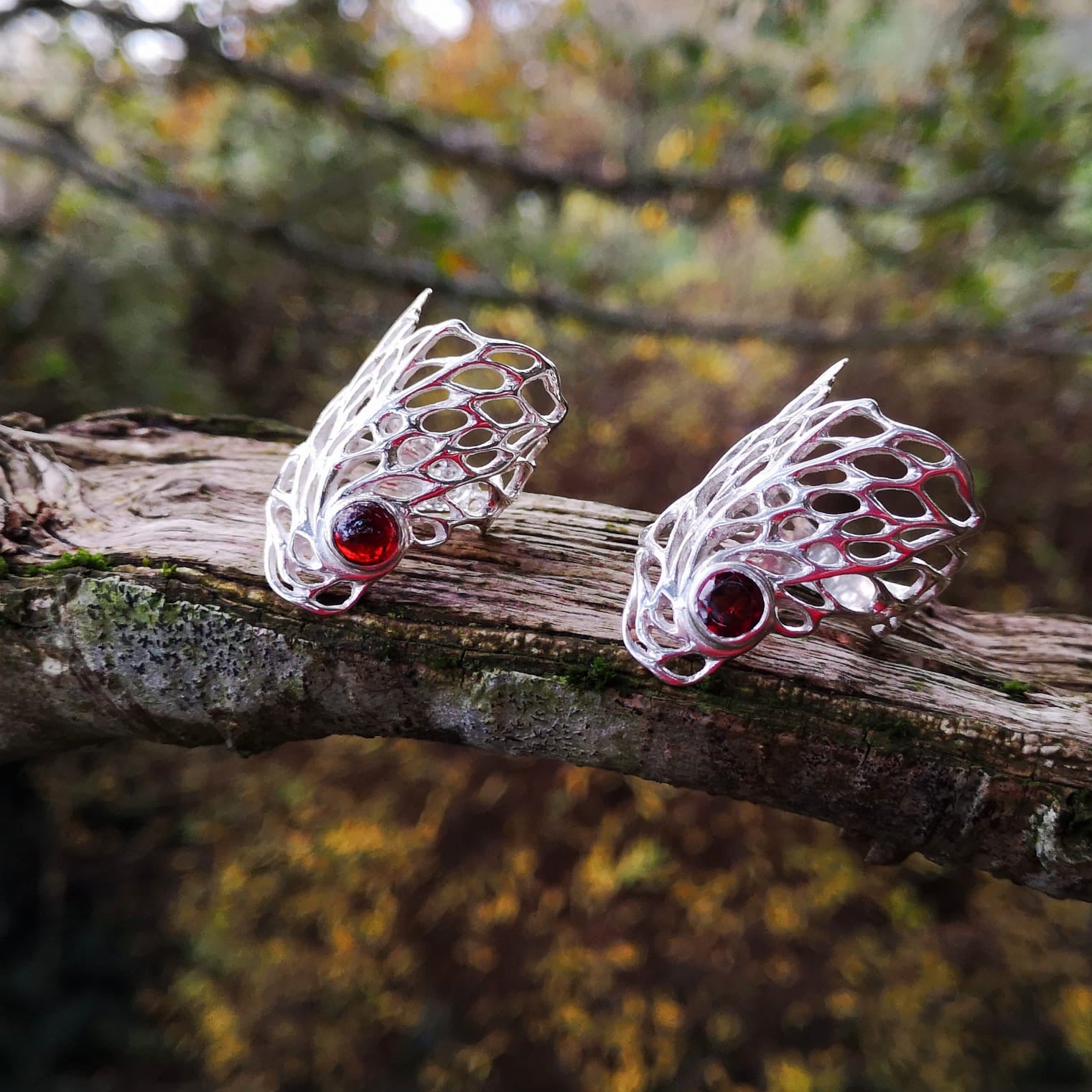 Ethereal Gossamer Stament Rings with different cuts of garnet gemstones nestled within, handmade by Irish jewellery designer Elena Brennan in Cavan, Ireland.